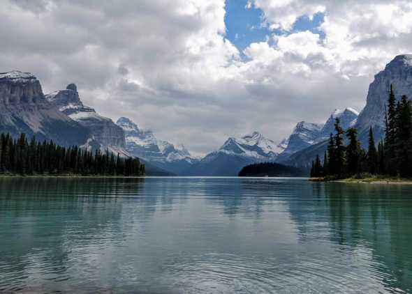 Nine snow-capped mountains surrounding turqoise waters of Maligne Lake